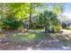Charming home with a well-maintained front yard, mature trees, and stone benches at 683 Edmonds Dr, Charleston, SC 29412