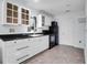 Well-lit kitchen with white cabinets, black countertop, stainless steel sink, and black appliances at 683 Edmonds Dr, Charleston, SC 29412