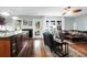 An open living room featuring hardwood floors, a kitchen bar and view to a back door and window at 683 Edmonds Dr, Charleston, SC 29412