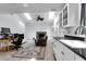 Cozy living room with fireplace and skylights, seamlessly connected to a modern kitchen area at 683 Edmonds Dr, Charleston, SC 29412