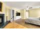 Main bedroom with fireplace and mounted tv with ensuite bathroom at 683 Edmonds Dr, Charleston, SC 29412