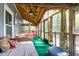 Relaxing screened porch with ceiling fan, comfortable seating, and views of the surrounding greenery at 683 Edmonds Dr, Charleston, SC 29412