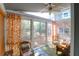 Bright sunroom with floor-to-ceiling windows, comfortable seating, and charming decor at 683 Edmonds Dr, Charleston, SC 29412