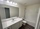 Functional bathroom with a large mirror, a vanity with sink, a toilet, and a shower-tub combo at 700 Pisces Ln, Summerville, SC 29486