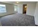 Spacious bedroom with soft carpeting, bright windows providing natural light, and access to an attached bathroom at 700 Pisces Ln, Summerville, SC 29486