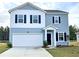 Charming two-story home with blue siding, white accents, and a two-car garage at 700 Pisces Ln, Summerville, SC 29486