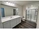 Bathroom featuring a sleek vanity, large mirror, and a glass-enclosed shower at 707 Pisces Ln, Summerville, SC 29486