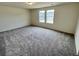 Spacious bedroom with neutral carpeting and two windows providing natural light at 707 Pisces Ln, Summerville, SC 29486