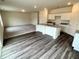 Open-concept kitchen with a kitchen island, granite countertops, and luxury vinyl plank flooring at 707 Pisces Ln, Summerville, SC 29486