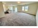 Spacious living room with plush carpeting and modern open concept kitchen at 707 Pisces Ln, Summerville, SC 29486
