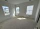 Bright bedroom with multiple windows, offering abundant natural light and neighborhood views at 717 Blueway Ave, Summerville, SC 29486