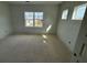 A bedroom with natural light filtering through large windows, showcasing neighborhood views at 717 Blueway Ave, Summerville, SC 29486