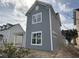 Gray, two-story home featuring white trim and bright windows, as well as a covered carport at 717 Blueway Ave, Summerville, SC 29486