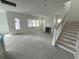 Living room featuring a fireplace, staircase, door to the outside, and windows at 717 Blueway Ave, Summerville, SC 29486