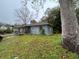 Backyard view of a weathered single-story home needing repair and lawn maintenance at 75 Rentz St, Varnville, SC 29944