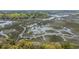 Breathtaking aerial view of the property and surrounding waterways, highlighting its unique location and natural beauty at 755 Jumbo Ln, Edisto Island, SC 29438