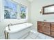 Stylish bathroom featuring a soaking tub, dual vanity and a picturesque window view at 755 Jumbo Ln, Edisto Island, SC 29438