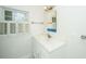 Bathroom with a vanity featuring a white countertop and sink, and a window with shutters at 755 Jumbo Ln, Edisto Island, SC 29438