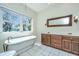 Bright bathroom with a soaking tub, dual sink vanity and natural light at 755 Jumbo Ln, Edisto Island, SC 29438