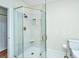 Bathroom featuring a glass shower with gold fixtures and a built-in shelf at 755 Jumbo Ln, Edisto Island, SC 29438