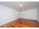 Bedroom with hardwood floors, white walls, and two windows with white shutters at 755 Jumbo Ln, Edisto Island, SC 29438