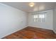 Bedroom with hardwood floors, white walls, and natural light from the windows at 755 Jumbo Ln, Edisto Island, SC 29438