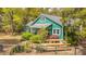 Charming home exterior with a wooden deck, manicured bushes, and colorful landscaping at 755 Jumbo Ln, Edisto Island, SC 29438
