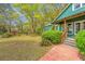 View of home, trees and brick walk-up to the covered front porch at 755 Jumbo Ln, Edisto Island, SC 29438