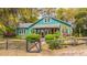 Charming green home with lush landscaping, mature trees and inviting front porch at 755 Jumbo Ln, Edisto Island, SC 29438