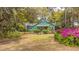 Quaint home with a welcoming front exterior, beautiful landscaping, and a charming garden at 755 Jumbo Ln, Edisto Island, SC 29438