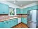 Updated kitchen with stainless steel refrigerator, custom cabinets, and light tile backsplash at 755 Jumbo Ln, Edisto Island, SC 29438