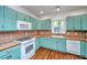 Charming kitchen features custom cabinets, modern appliances, and tile countertops at 755 Jumbo Ln, Edisto Island, SC 29438