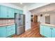 Open kitchen flows into the living area, featuring a stainless steel refrigerator and custom cabinets at 755 Jumbo Ln, Edisto Island, SC 29438