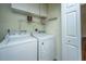 Laundry room with Whirlpool washer and dryer, overhead cabinets and wire shelving at 755 Jumbo Ln, Edisto Island, SC 29438