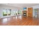 Living area featuring hardwood floors, fireplace with TV, and french doors to outdoor area at 755 Jumbo Ln, Edisto Island, SC 29438