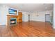 Open living space featuring hardwood floors, fireplace with mounted TV, and neutral walls at 755 Jumbo Ln, Edisto Island, SC 29438