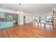 Open floorplan showing hardwood floors and an eating area with retro kitchen in the background at 755 Jumbo Ln, Edisto Island, SC 29438