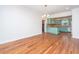 Open floorplan living room and view of retro kitchen with hardwood floors and chandelier at 755 Jumbo Ln, Edisto Island, SC 29438