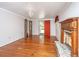 Spacious living room with hardwood floors, a fireplace, and an open doorway at 755 Jumbo Ln, Edisto Island, SC 29438