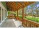 Charming covered porch with wooden railings and view of landscaped backyard at 755 Jumbo Ln, Edisto Island, SC 29438