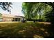 Spacious backyard featuring a covered patio, large grassy area, and wooded perimeter, perfect for outdoor activities at 7605 Ireland Dr, North Charleston, SC 29420