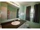 Refreshing bathroom featuring a vanity, large mirror, and shower/tub combo for relaxation and convenience at 7605 Ireland Dr, North Charleston, SC 29420
