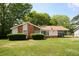 Charming single-story home featuring a brick accent wall and an American flag displayed in the front yard at 7605 Ireland Dr, North Charleston, SC 29420