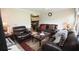 Spacious living room boasts comfortable leather furniture, elegant decor, and an open layout to the kitchen at 7605 Ireland Dr, North Charleston, SC 29420