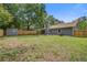 Large backyard featuring a fence, shed, covered patio, and grassy lawn at 780 Corral Dr, Charleston, SC 29414