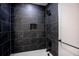 Modern bathroom featuring sleek, dark tile shower and a convenient built-in niche for storage at 780 Corral Dr, Charleston, SC 29414