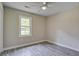 A light-filled room with a ceiling fan, plank floors and a large window at 780 Corral Dr, Charleston, SC 29414