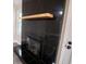 Close-up of fireplace with sleek black tile surround and natural wood mantle at 780 Corral Dr, Charleston, SC 29414