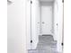 Bright hallway with gray wood-look flooring and white paneled doors at 780 Corral Dr, Charleston, SC 29414