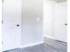 Hallway showcasing modern gray flooring, white trim, and clean design at 780 Corral Dr, Charleston, SC 29414